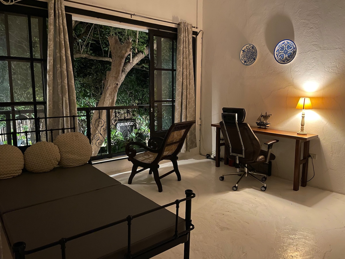 Casa Uno bedroom with iron bed and work desk